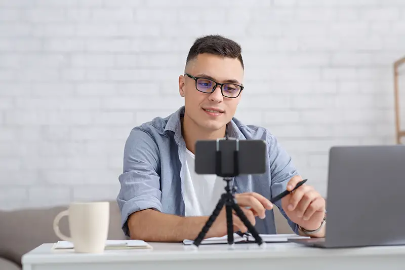 Young man students working as tutor online