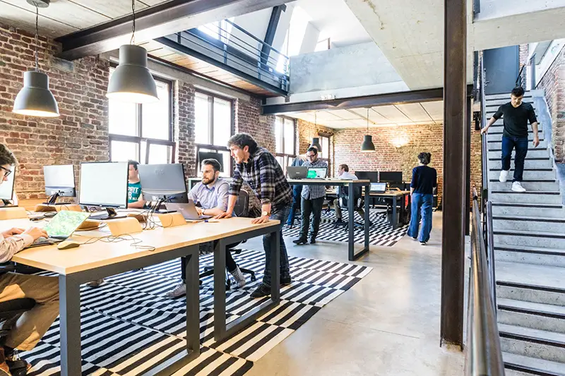 people working in the office with computers on table