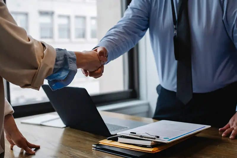 Colleagues shaking hands in the office