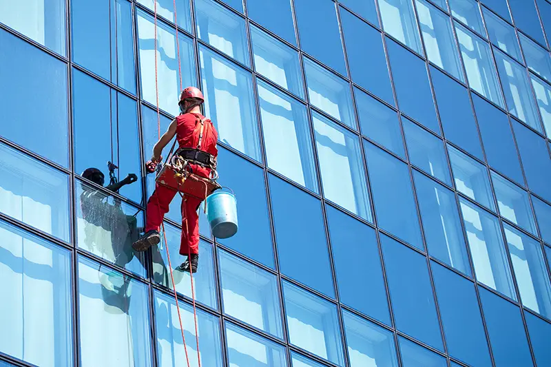Man cleaning building glass window