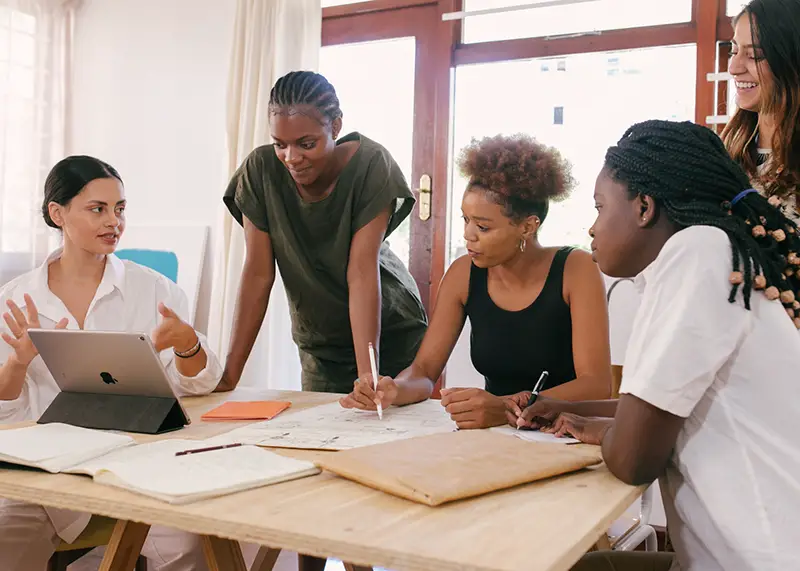 Women having team meeting