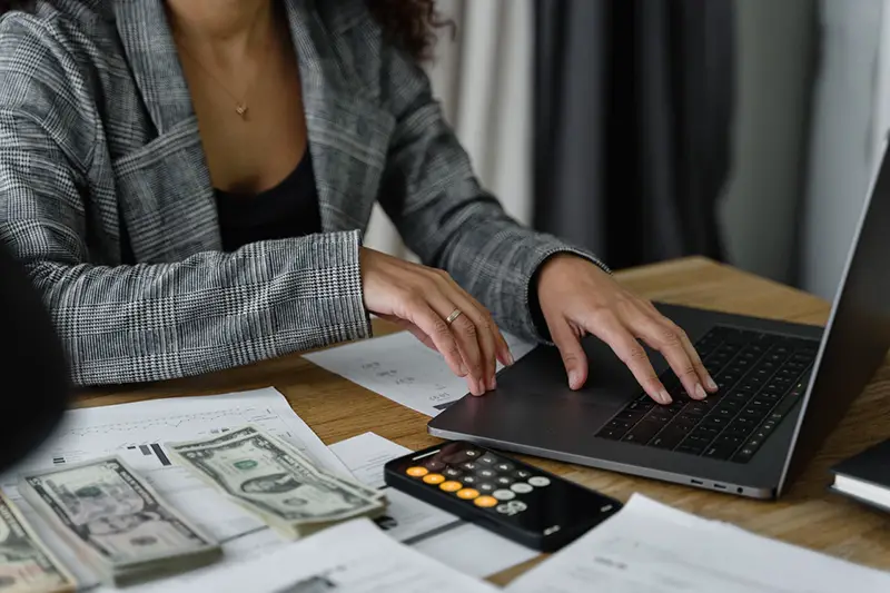 business woman working on computer software and counting money for payroll