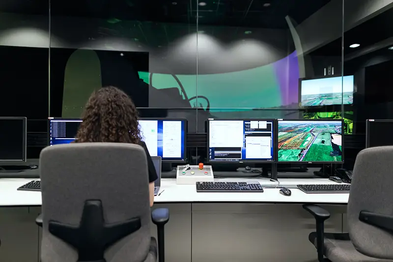 Woman sitting on black rolling chair in front of computer