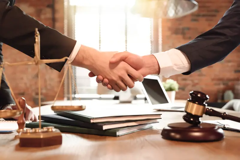Lawyer and his client handshake. Agreement with attorney in office