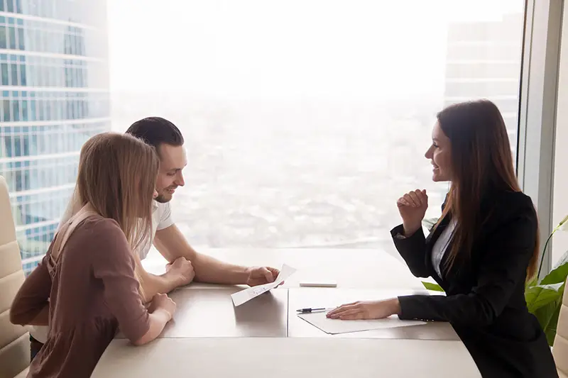 Real estate agent talking to a couple client