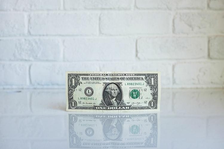 dollar bill on the white table