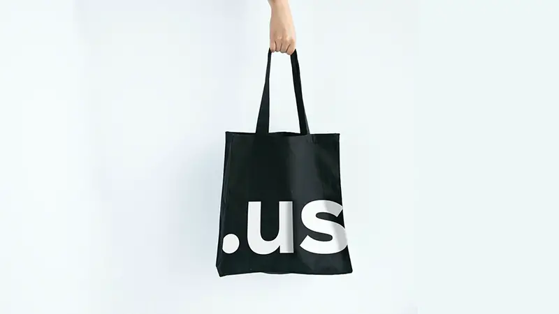 Hand holding black minimalistic design tote bag - branding