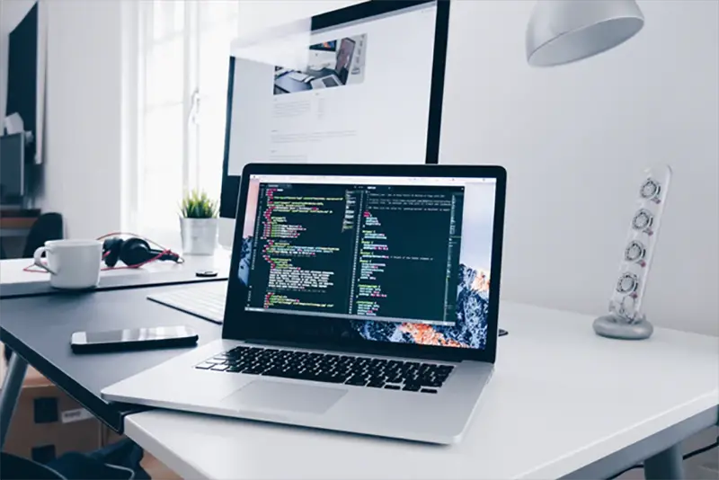 Laptop and computer on the top of white table