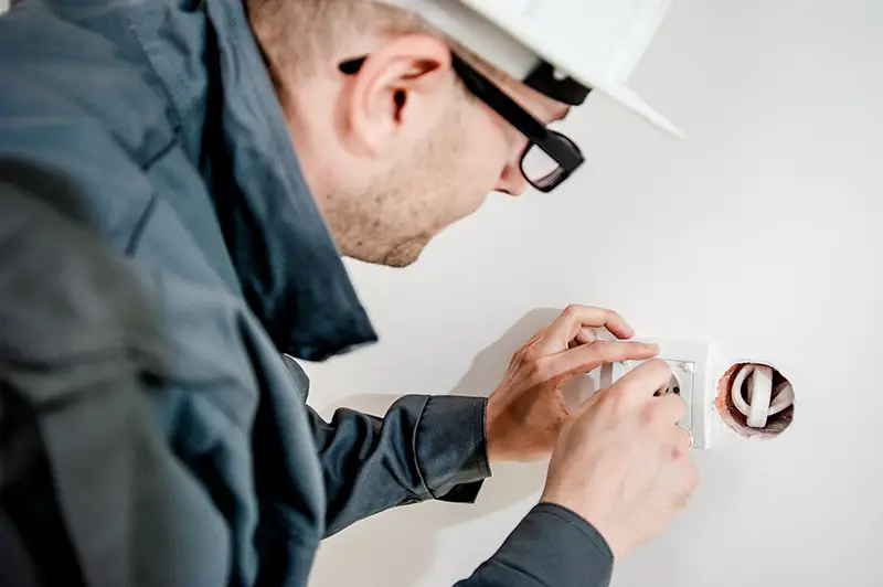 Electrician working with the electric wires