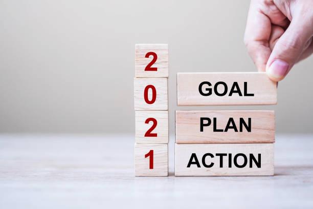 words goal, action, plan, and 2021 written on the wooden blocks