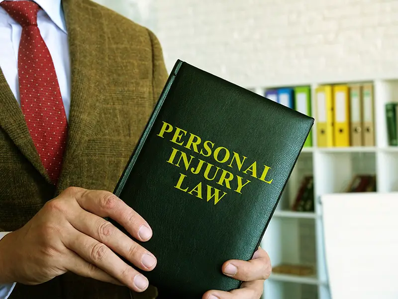 Lawyer holding personal injury law book