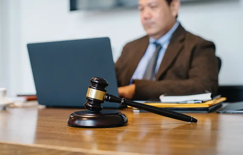 Judge gavel on the top of brown table