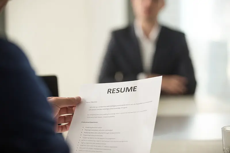 Woman Applicant and interviewer reading the  resume