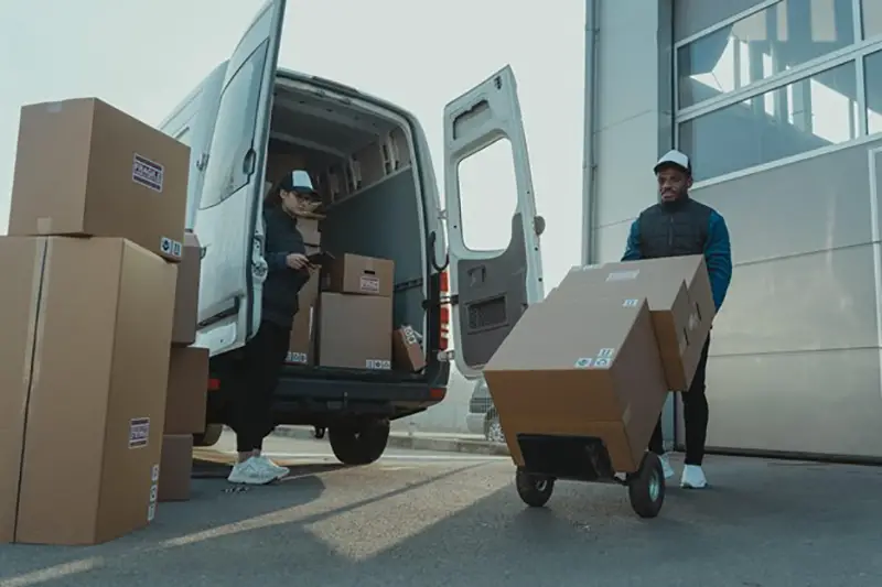 Man and woman near delivery van and boxes