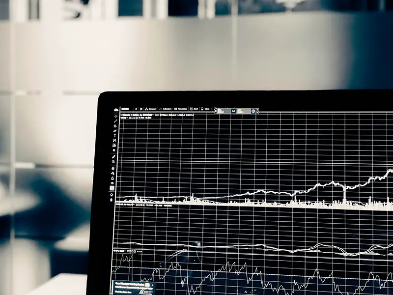 turned on flat screen monitor with graphs of stock market