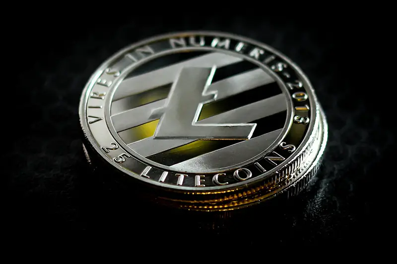 a litecoin on black background