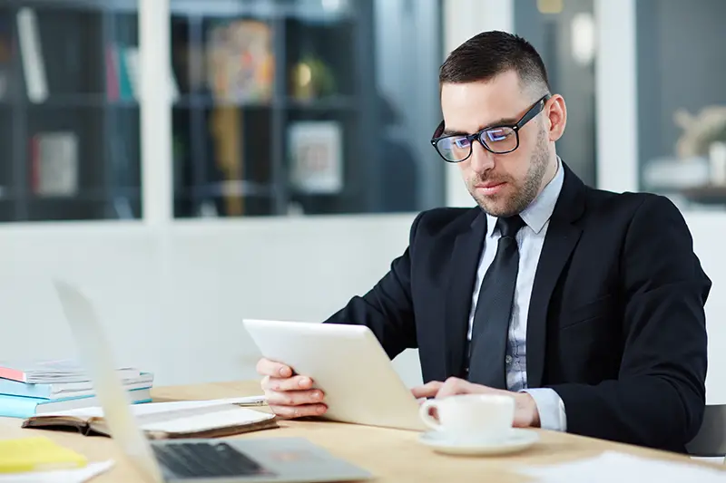 Business broker wearing black suit and eye glasses