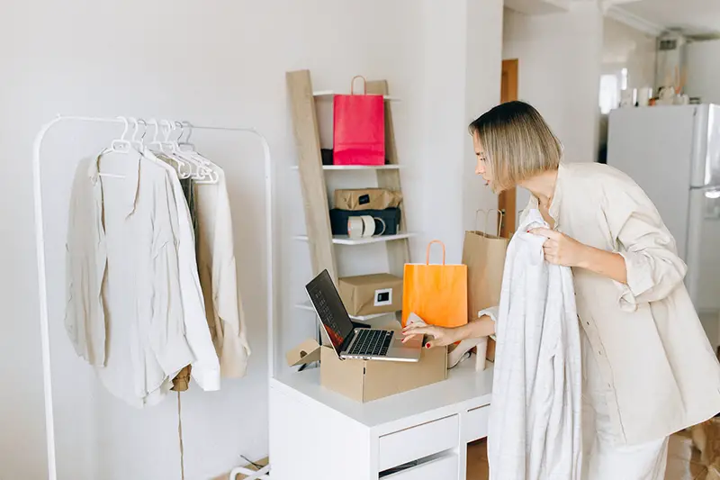 Woman in white dress standing in front of white wooden desk