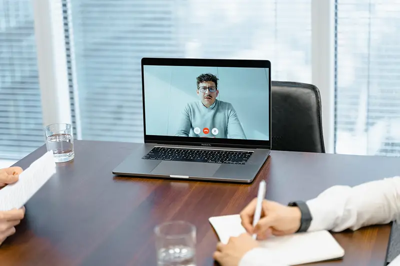 A businessman in an online meeting