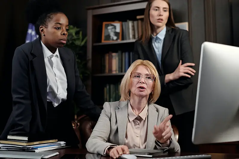 female lawyers in an office looking at the computer