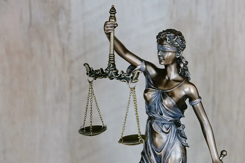 Lady justice wearing a blindfold and holding a sword and scales