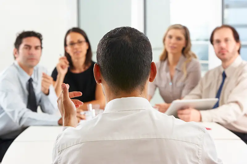 Businessman having meeting with his employees