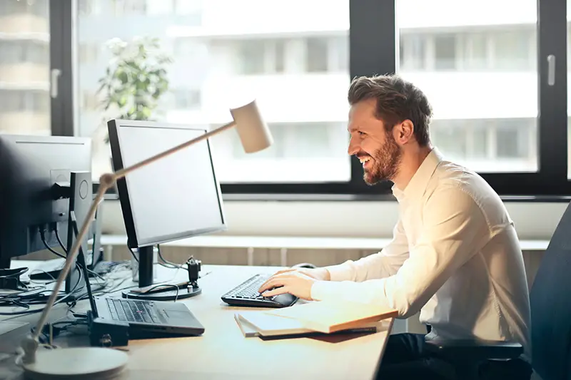 Happy man in long sleeves working in the office