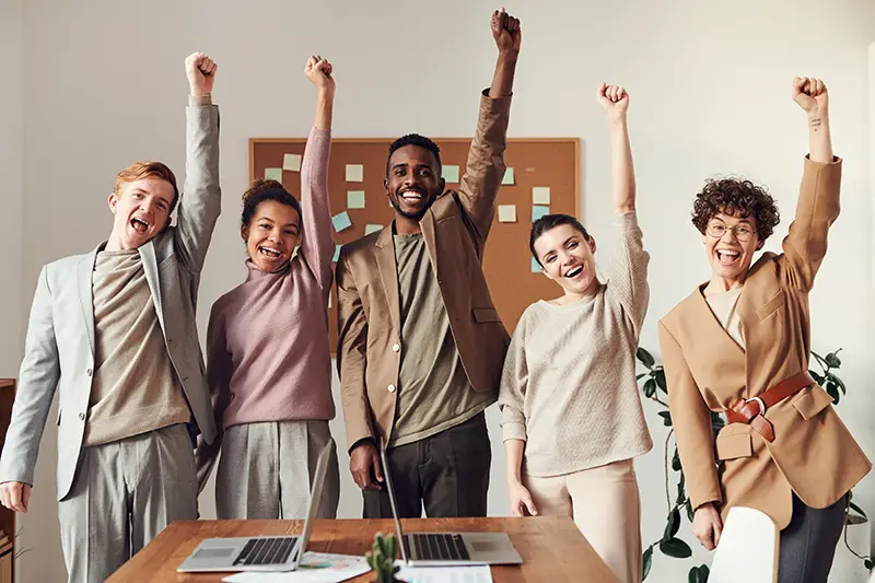 group of professionals raising their hands