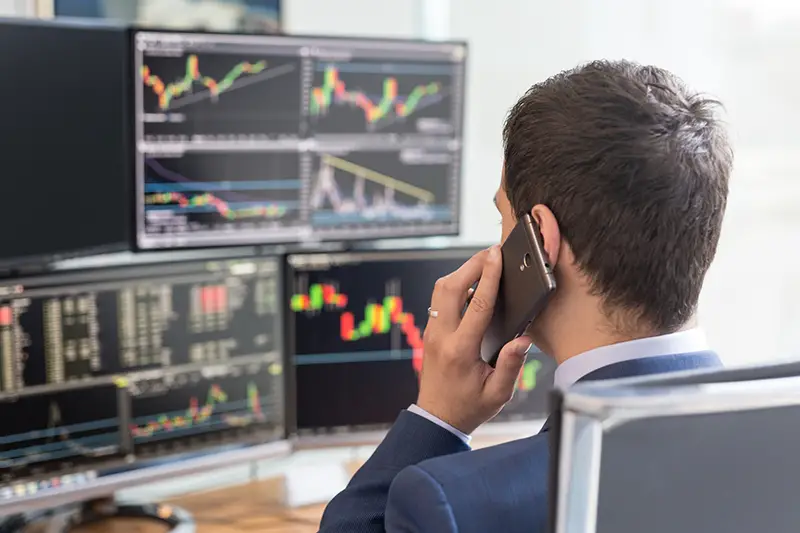 Businessman in front of trading chart on computer screen