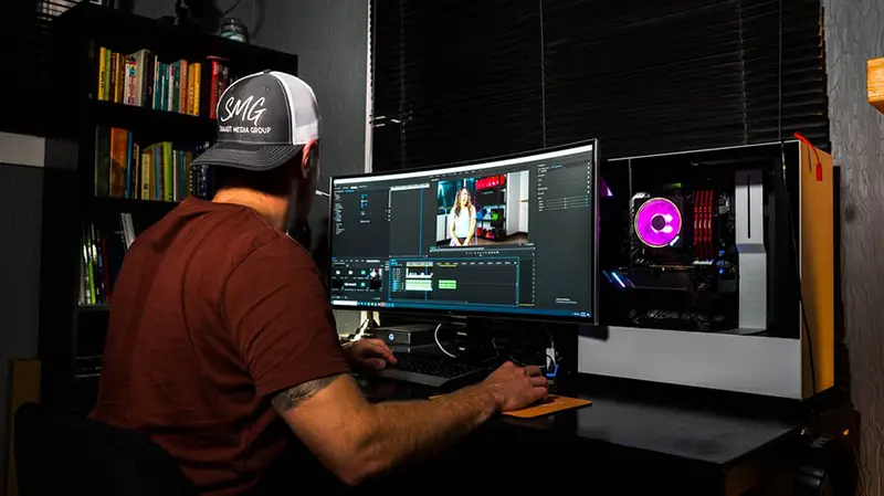 a man wearing a cap doing video editing
