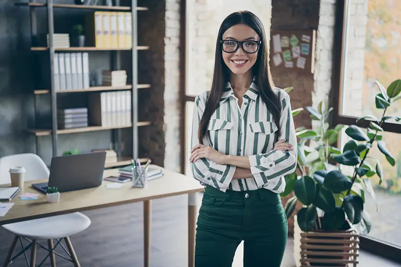 Smiling woman standing on her office