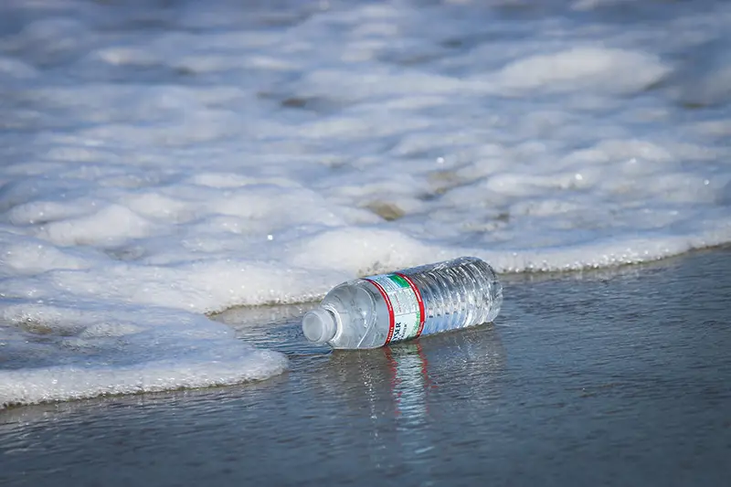 Water plastic bottle on the sea shore