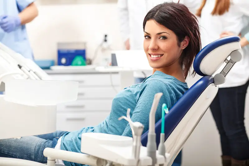 Young female patient sitting on chair in dental office.preparing for dental exam