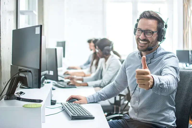 Happy man working in a call center