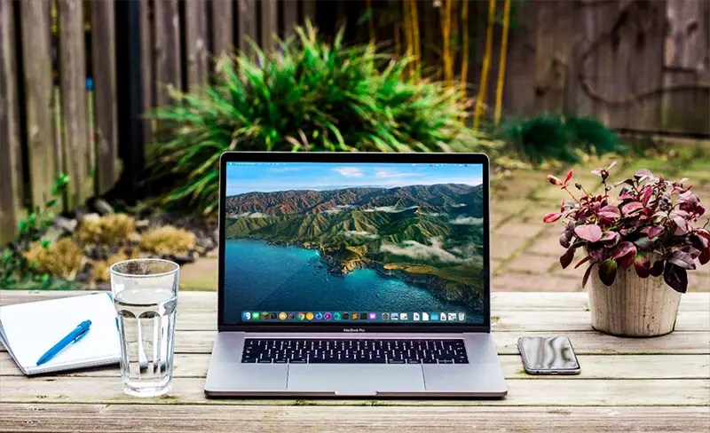 Black and silver laptop on the top of wooden table