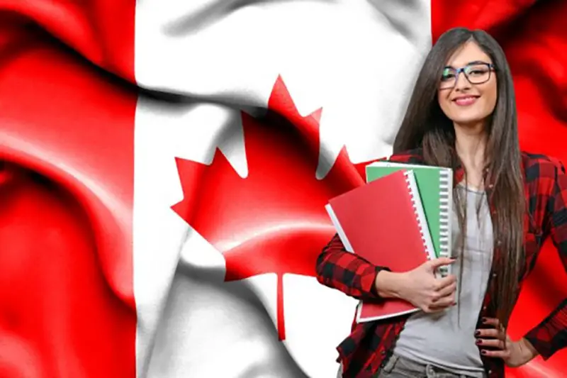 Girl student standing beside Canadian flag