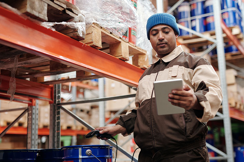 man holding a digital tablet inside the warehouse