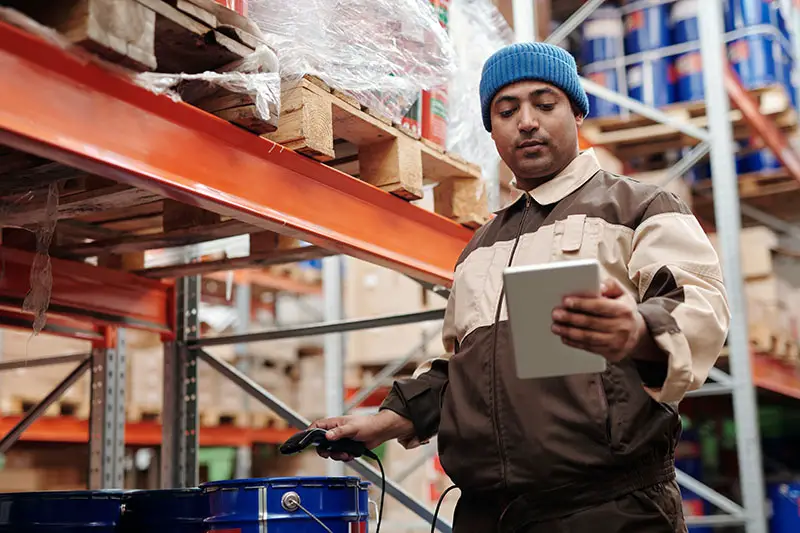 man holding a digital tablet inside the warehouse