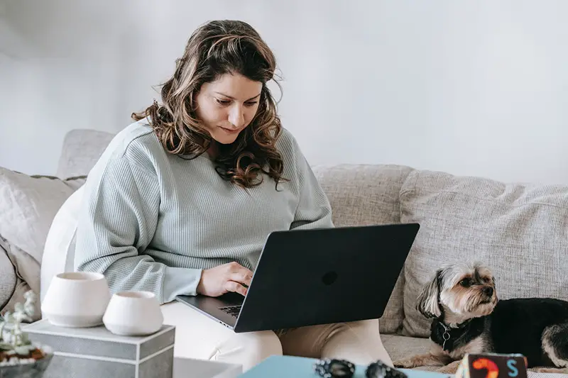 Focused female remote worker using netbook