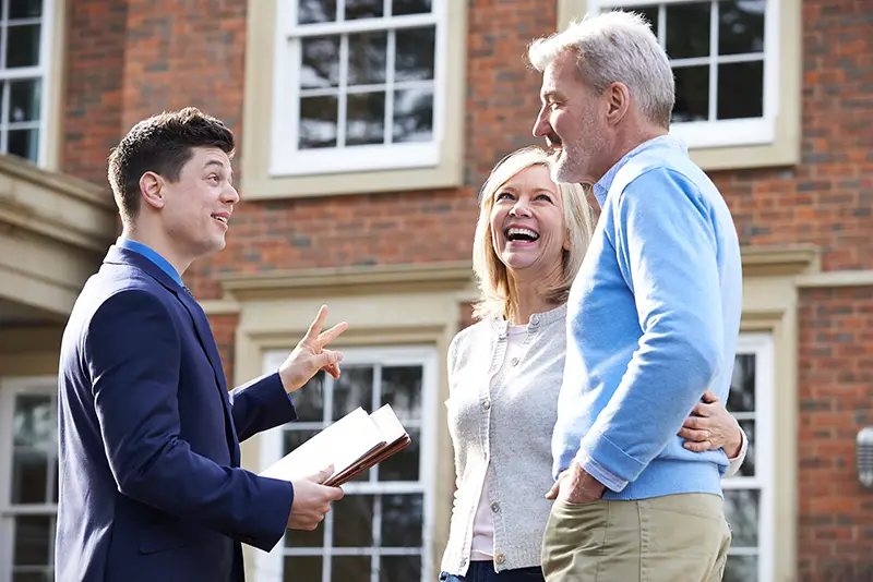 Real estate agent talking to a couple client