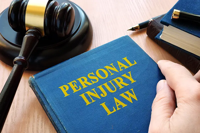 Personal injury law book and judge hammer