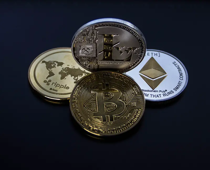 four assorted cryptocurrency coins