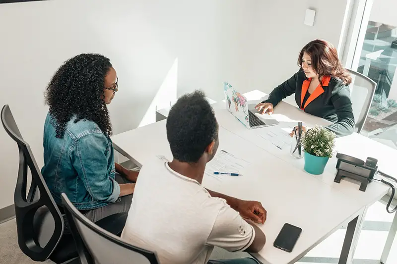 Couple client talking to a financial advisor