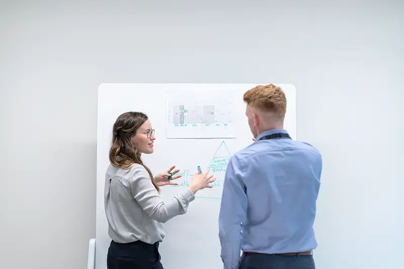 Man and woman discussing their engineering projects