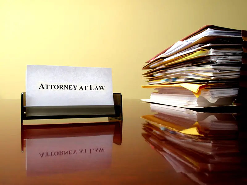 attorney at law signage near the pile of documents