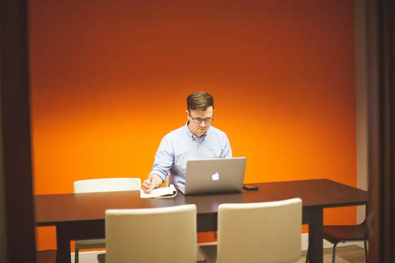 Man working in front of his laptop at home