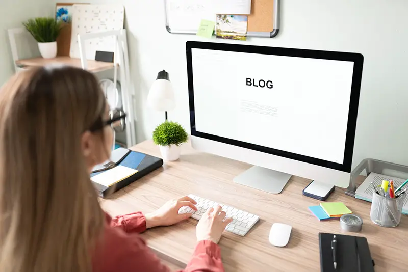 Woman wearing eyeglasses working in front of her computer