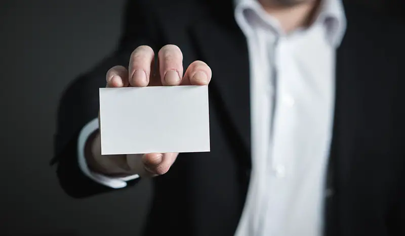Person holding blank business card