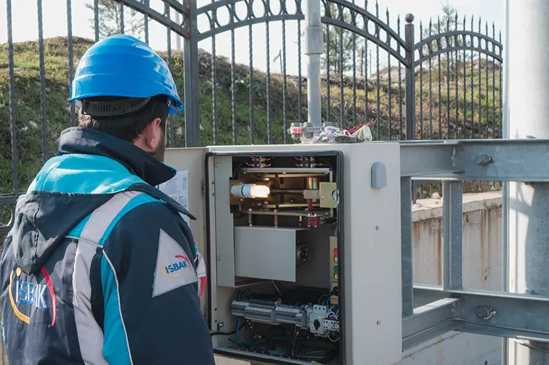 An electrician inspecting a fuse box