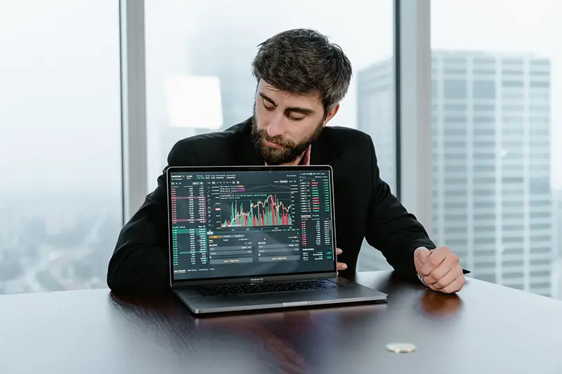 Man in black long sleeves shirt using black laptop computer